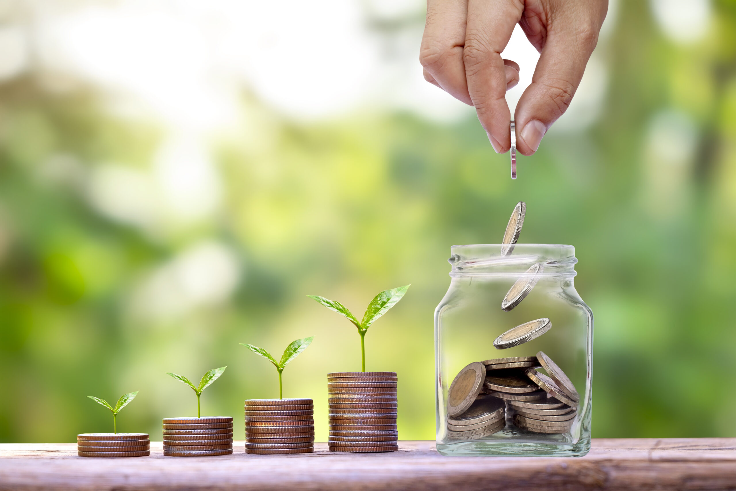 Vecteezy hand holding silver coins in a jar for saving money and 6654862 scaled
